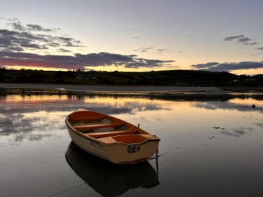 Boat on the estuary at sunset